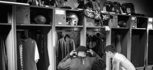 Illustration of a quarterback wearing XTECH Pads, highlighting optimal performance and protection, with symbols of agility and advanced gear.