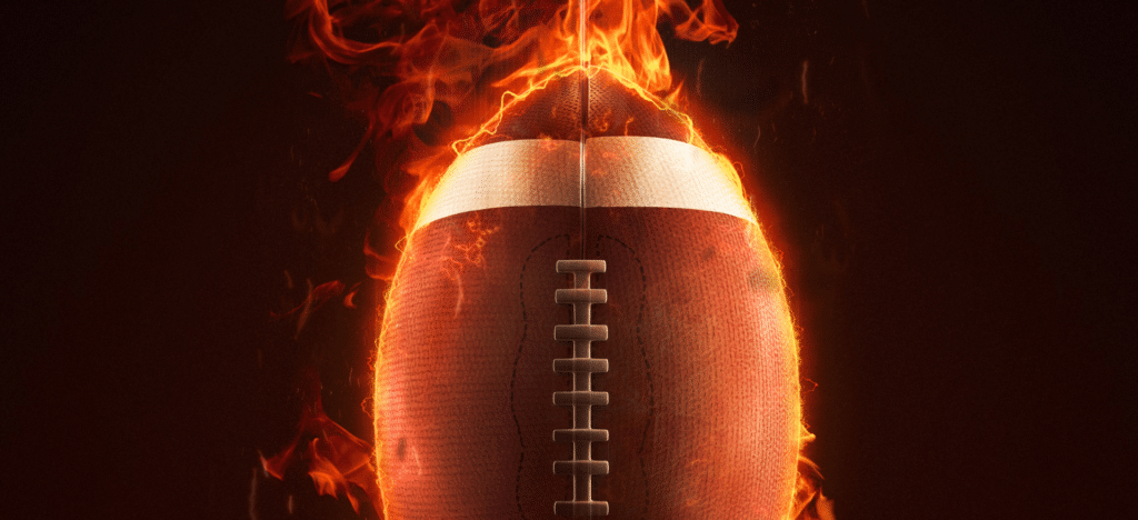 Football engulfed in flames, symbolizing intensity and passion for the sport.