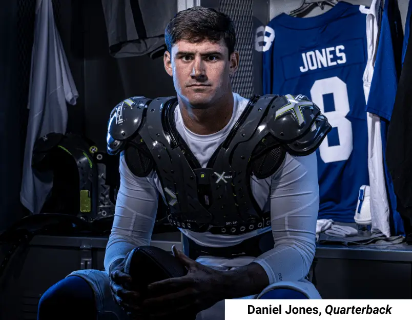 Football player wearing XTECH shoulder pads during game action