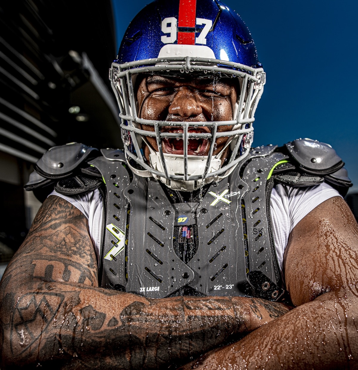 Football player wearing XTECH shoulder pads built for fit, coverage, and mobility.